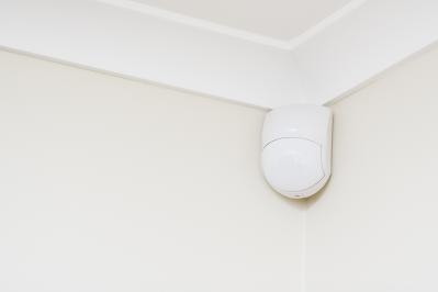 Movement detector in the top corner of a room